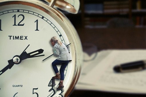 A clock with a woman climbing on it to measure time