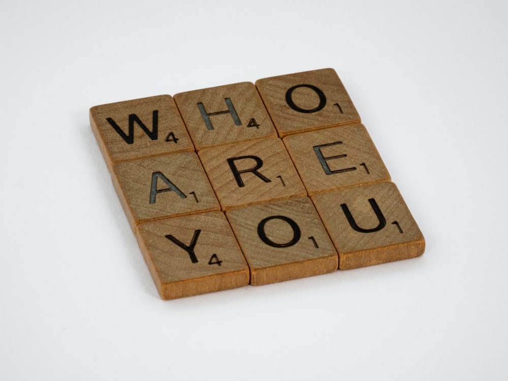Scrabble tiles spelling out the phrase "who are you"